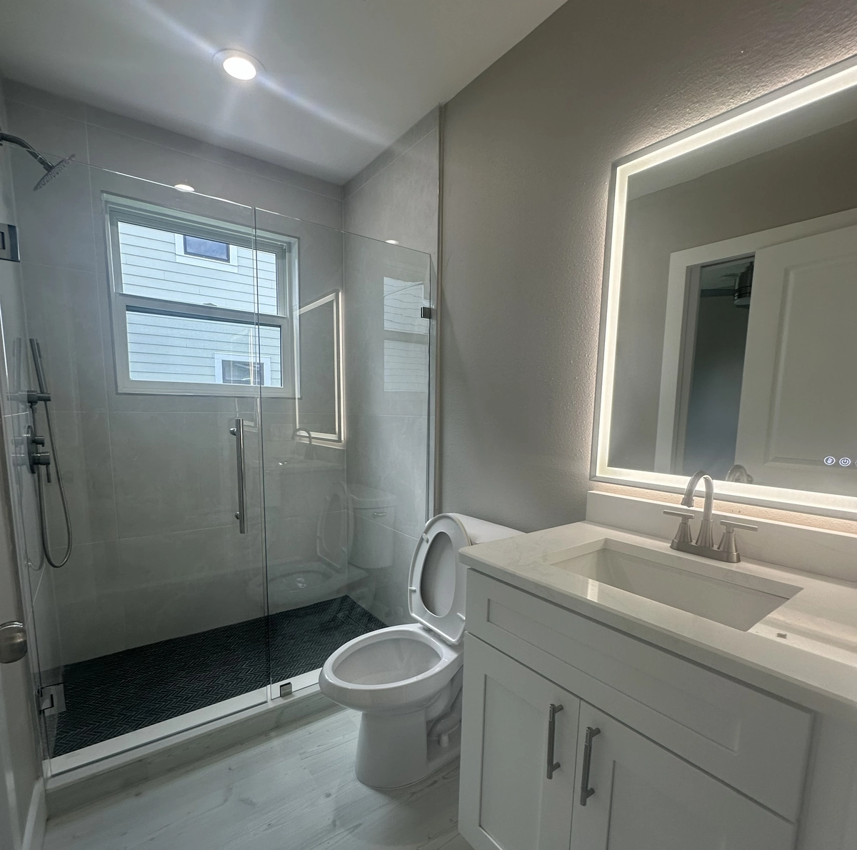 Remodeled Orlando bathroom with a tiled walk in shower by Guy A Remodeling