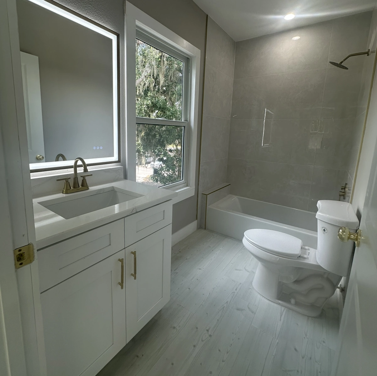 Remodeled bathroom with a low tub and shower by Guy A Remodeling
