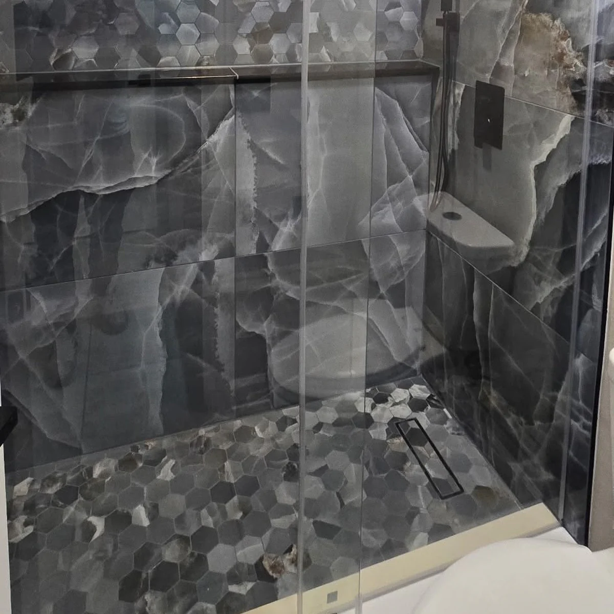 Finished tiled shower with a built in niche by Guy A Remodeling