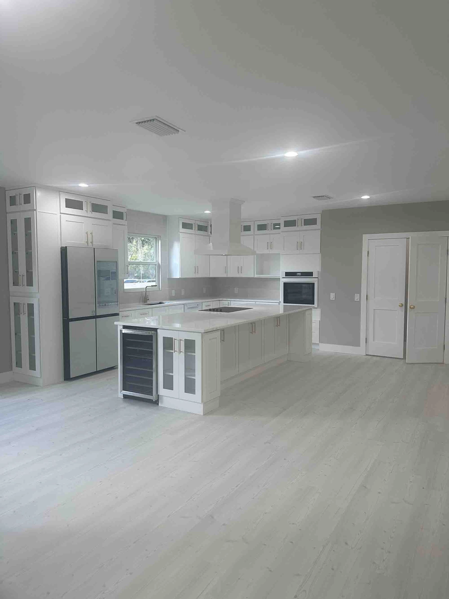 Finished remodeled Kissimmee kitchen with an island and modern cabinets by Guy A Remodeling