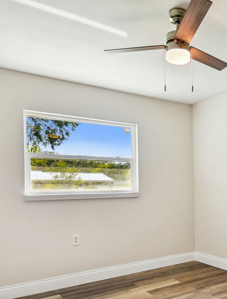 Finished replacement window with clean trim and daylight in a Central Florida room by Guy A Remodeling