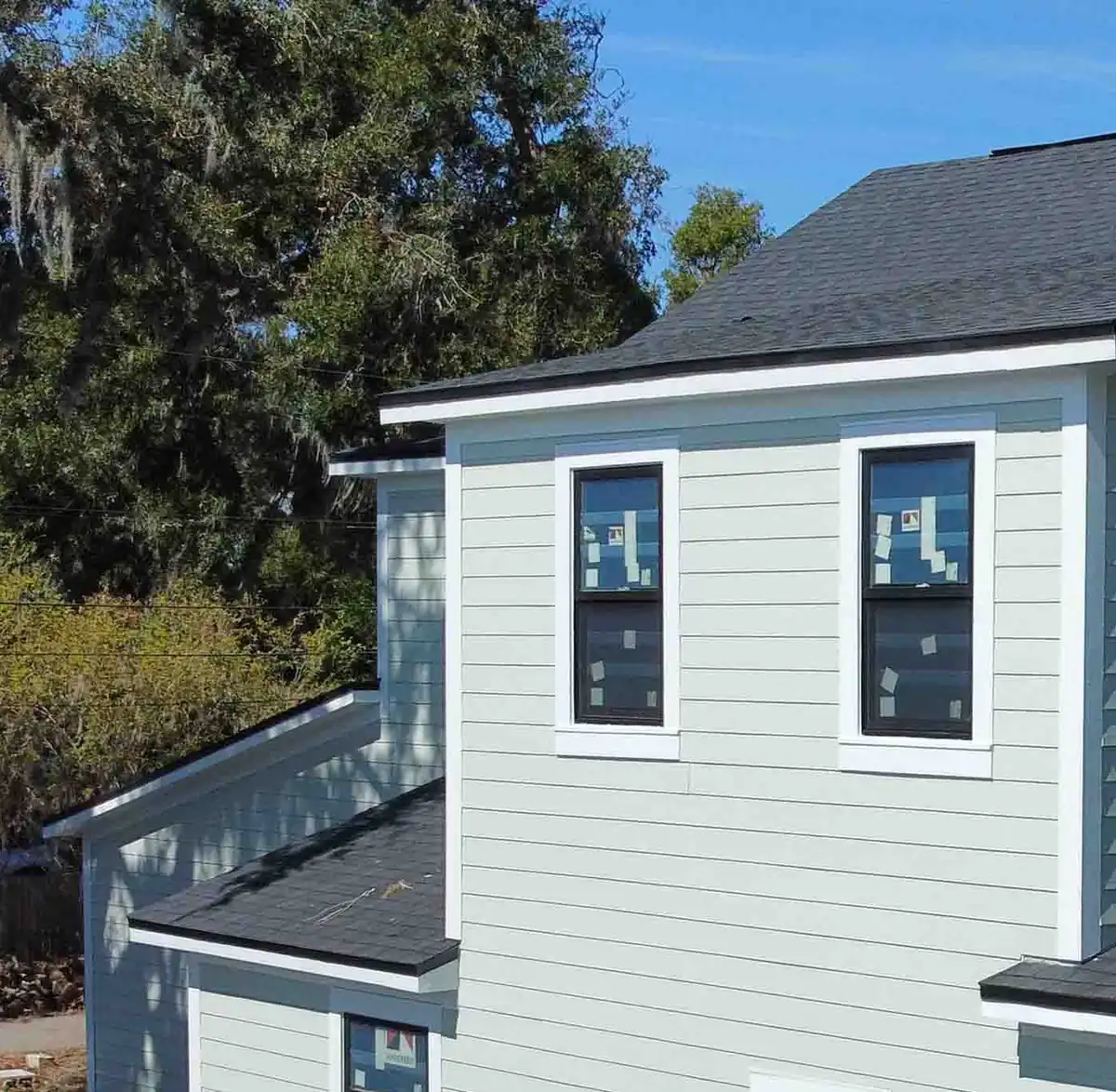 Installer setting a new replacement window square in the opening by Guy A Remodeling
