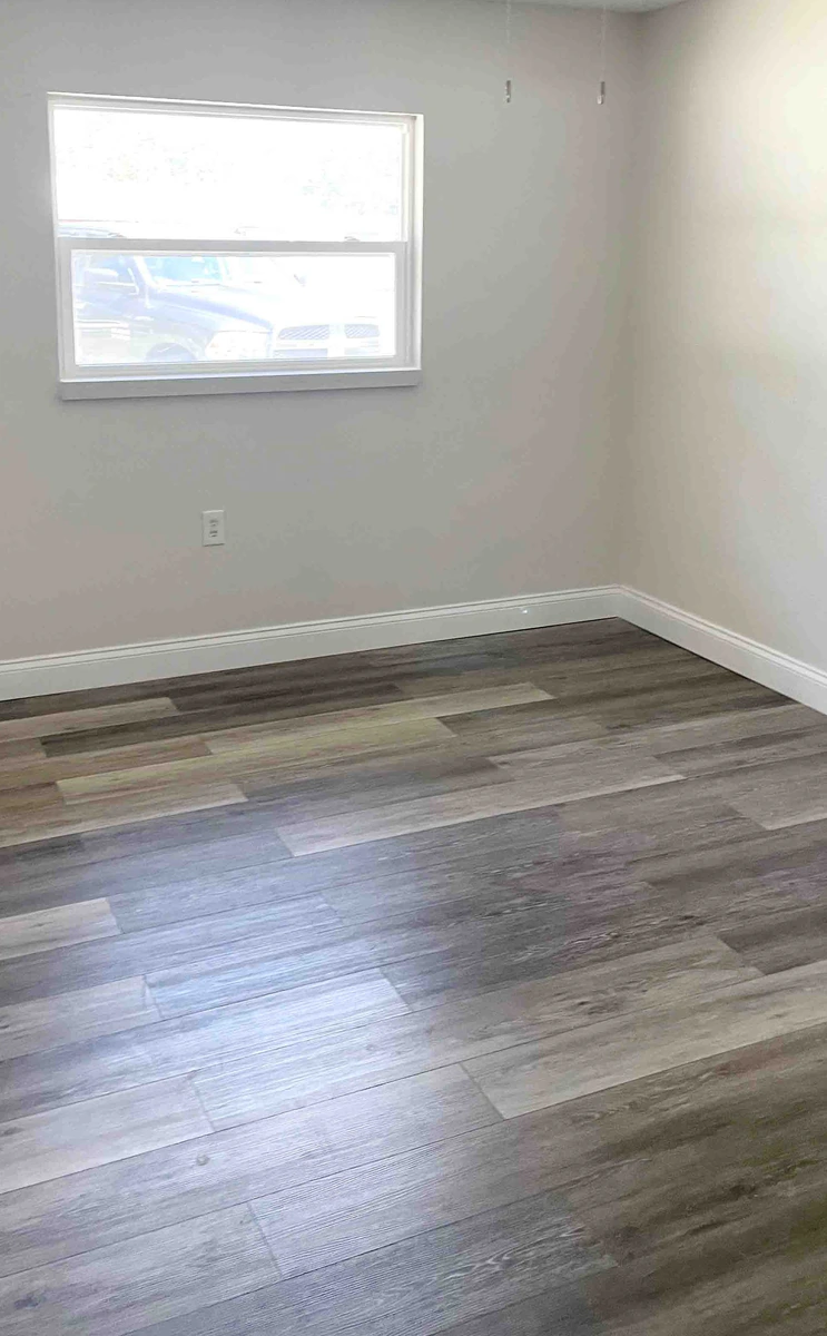 Level tile flooring set flat over a prepared slab in a Central Florida home by Guy A Remodeling