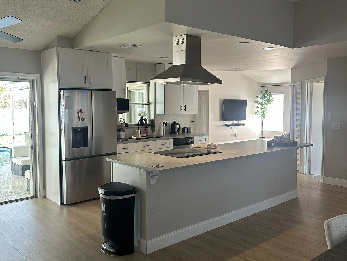 Remodeled Orlando kitchen with a large island and a stove by Guy A Remodeling