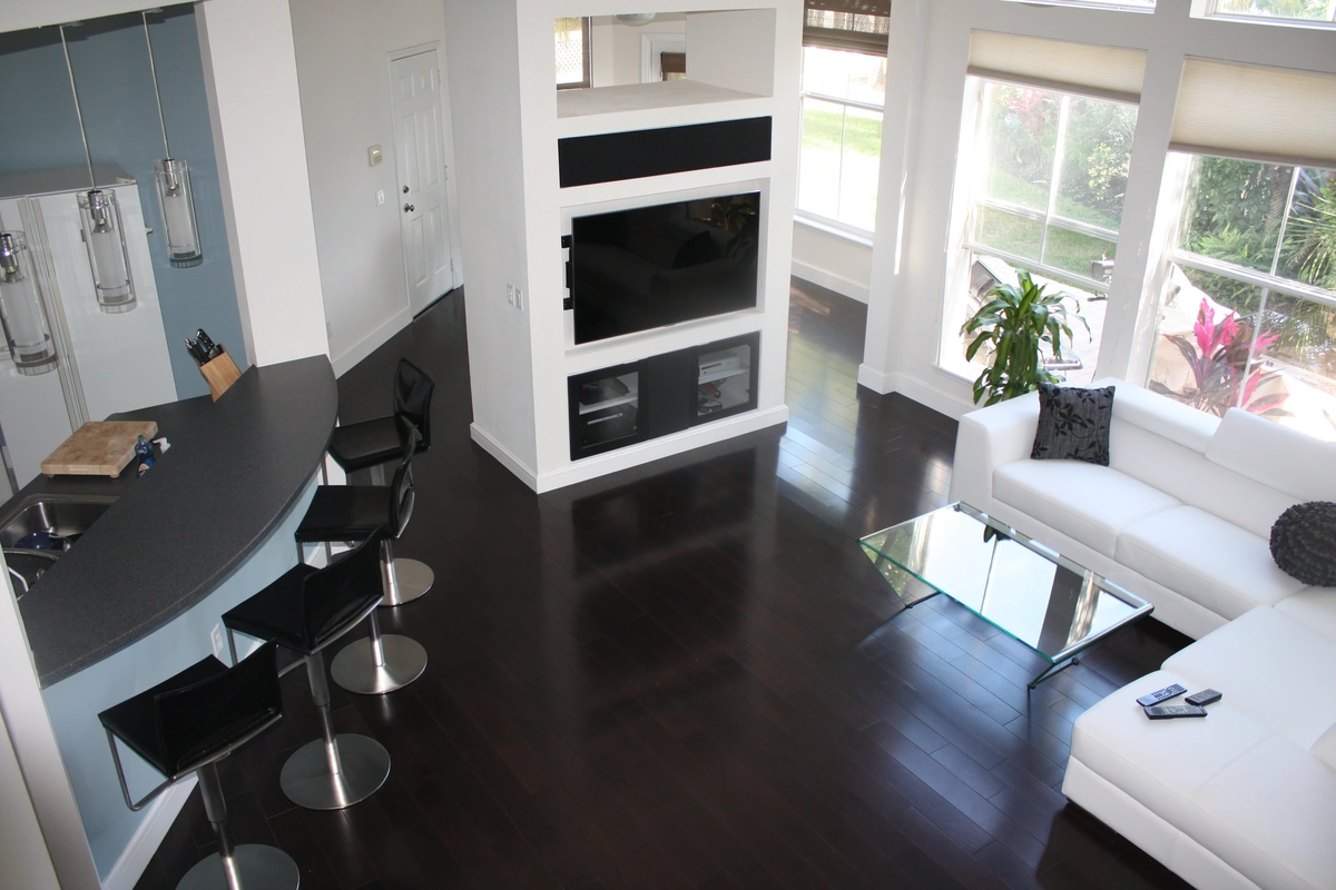 Remodeled living room with high ceilings and fresh paint by Guy A Remodeling