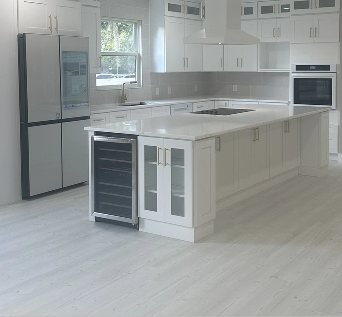 Large format tile and wood look plank samples in different tones and patterns by Guy A Remodeling