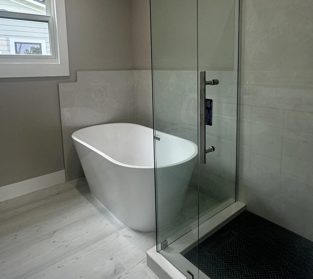 Bathroom remodel in progress showing the shower pan and cement board by Guy A Remodeling