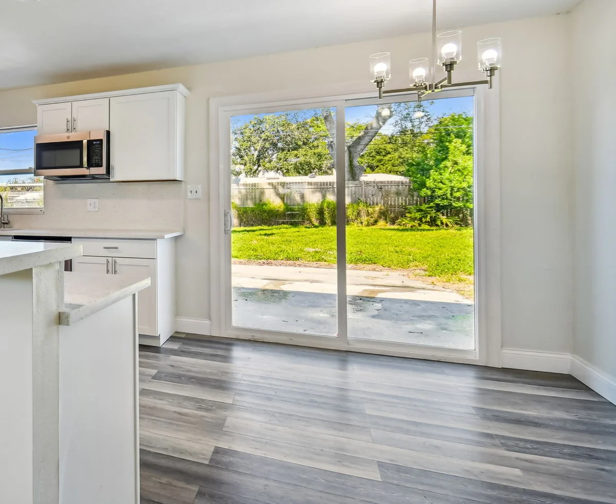 Sealed exterior entry door with weatherstripping and a solid threshold by Guy A Remodeling