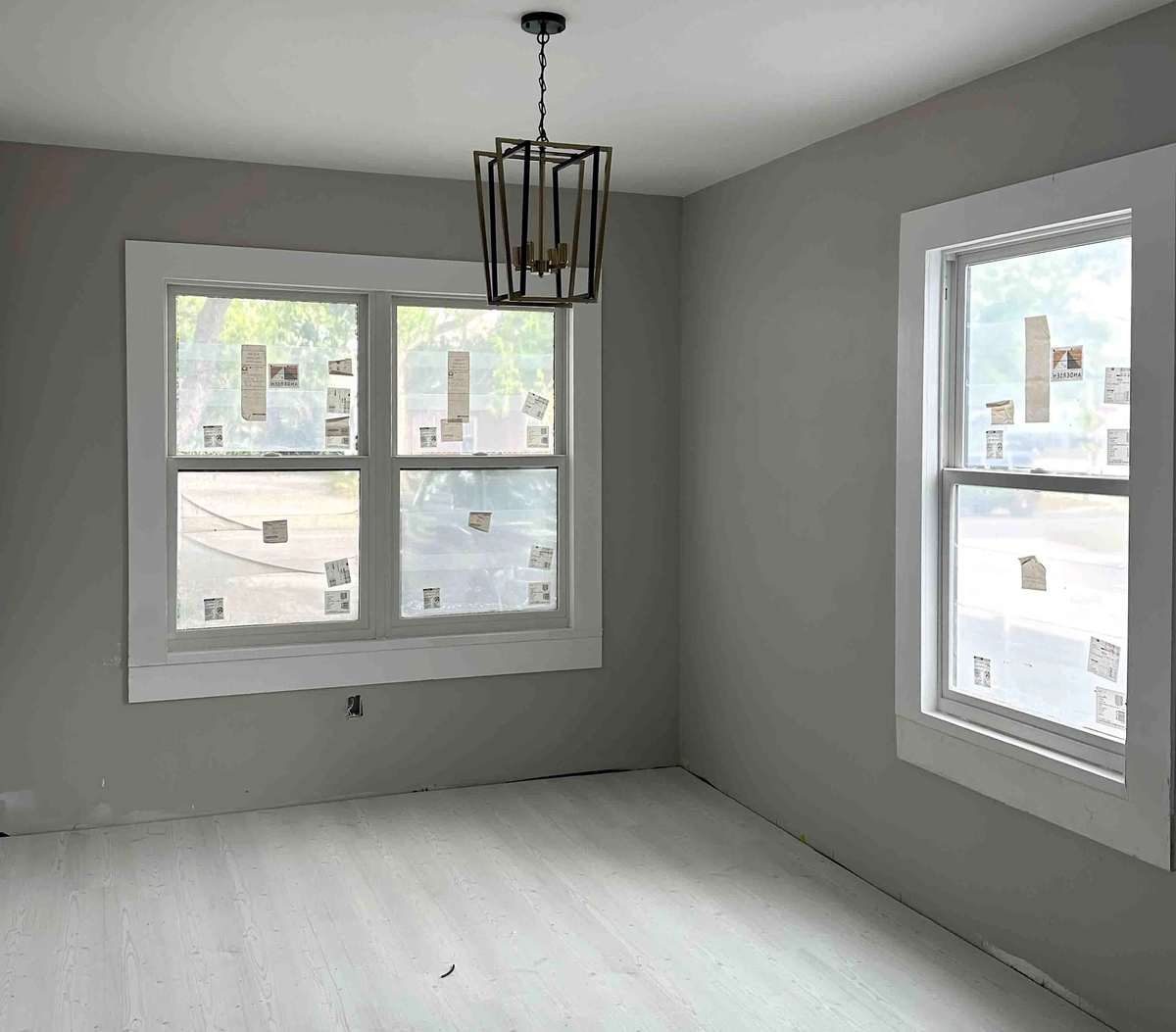 New window set square and sealed in the opening with finished trim by Guy A Remodeling