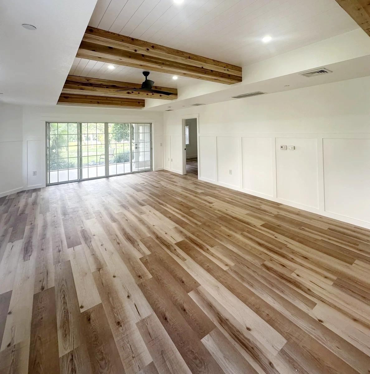 Tile and wood plank flooring installed flat and level in a remodeled Orlando home by Guy A Remodeling