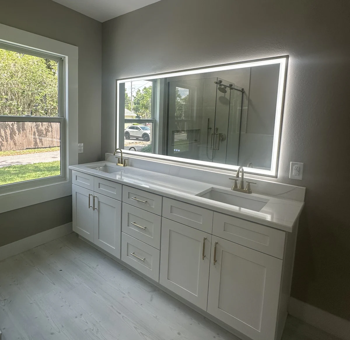 Remodeled bathroom with tile, a walk in shower, and a floating vanity by Guy A Remodeling