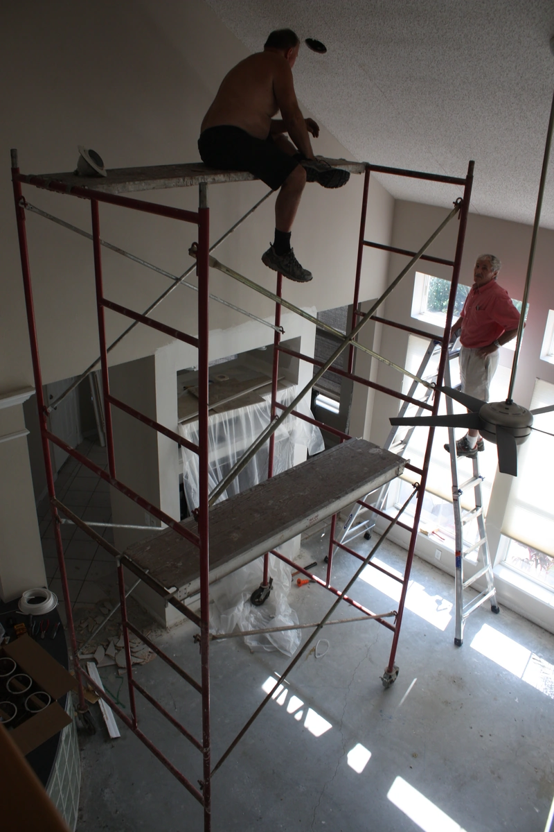 Workers on scaffolding during the high ceiling remodel in Kissimmee