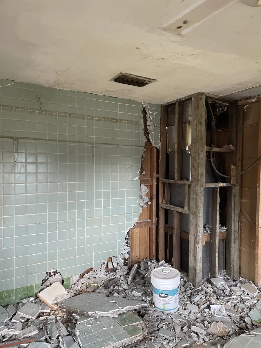 Interior demolition showing exposed brick and removed tile during the Lakeland rebuild