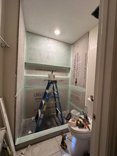 Cement board up and waterproofed in the Kissimmee shower, with the wall to wall niche recess coated in membrane