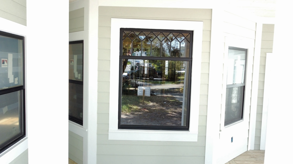 Rebuilt two story Lakeland home with white siding and a new porch by Guy A Remodeling