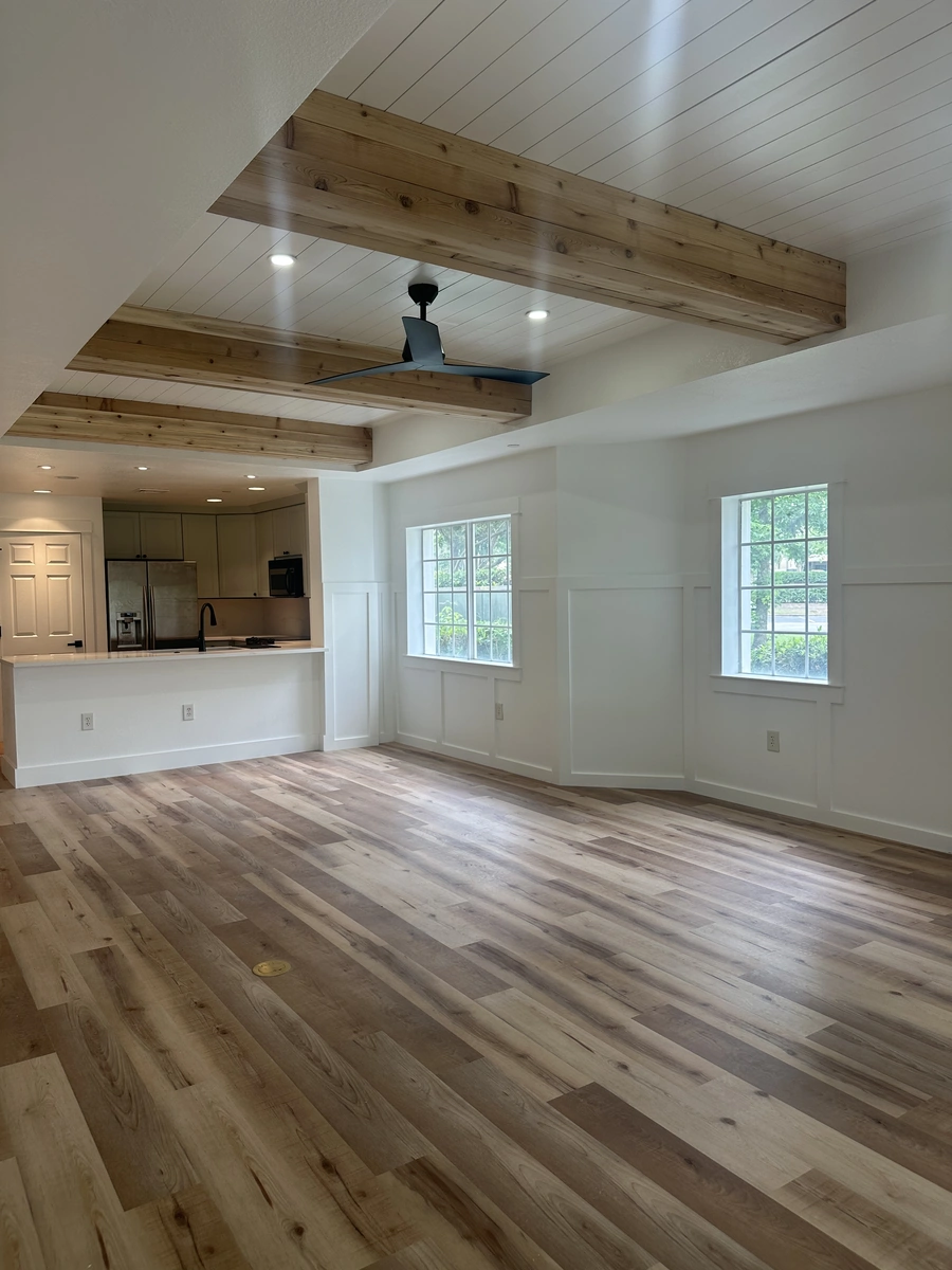 Finished open living and kitchen in Kissimmee with wood beams, recessed lighting, and wood floors