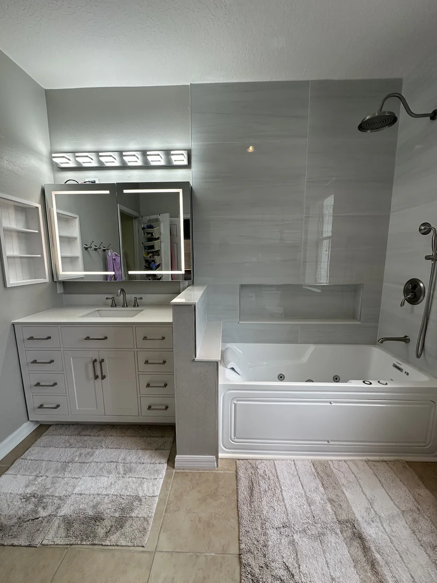 The same Celebration bathroom after the upgrade with a Jacuzzi tub in the original alcove and large format gray tile
